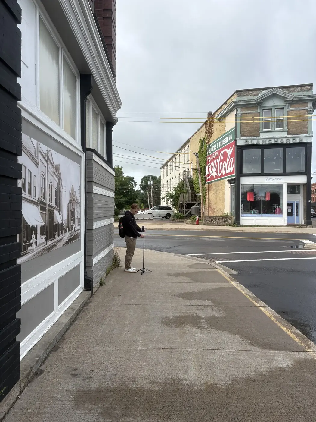 Jack setting up a tripod to capture content on a downtown Windsor street