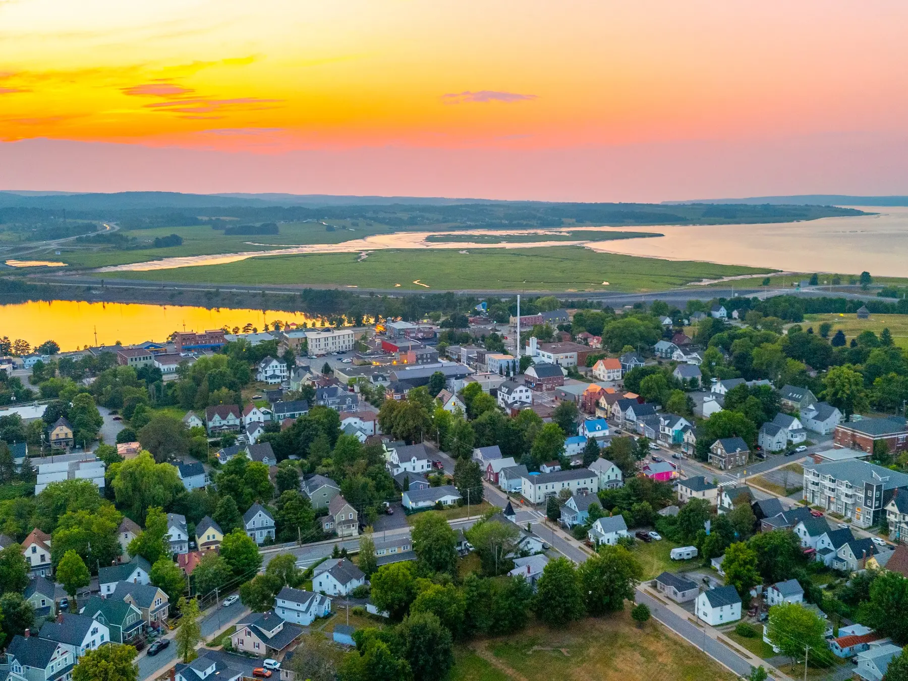 Aerial view of Windsor, Nova Scotia at sunrise, showing downtown, the waterfront, and surrounding landscape